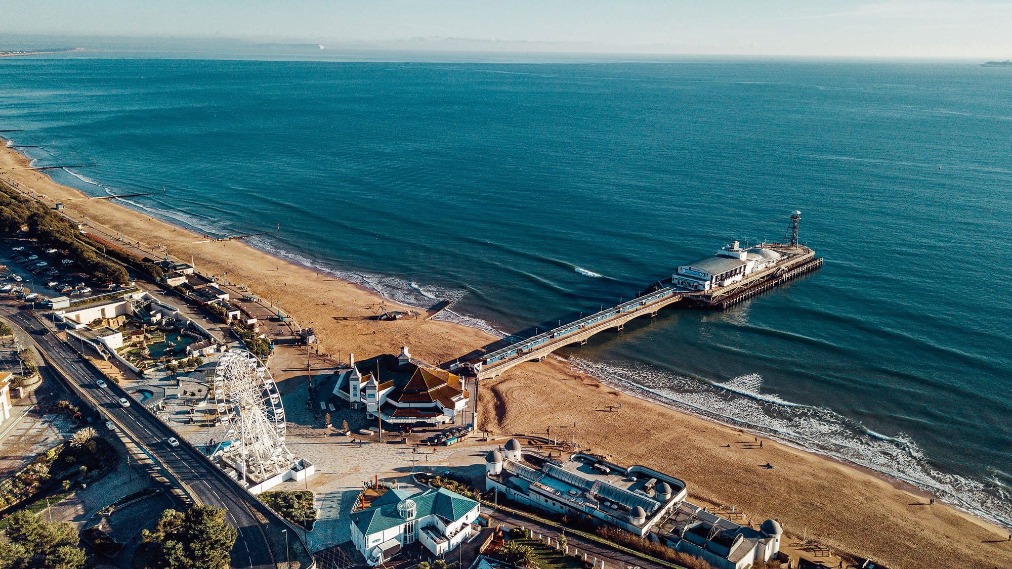 Aerial view over Bournemouth Pier and the bay, the beach curving away on both sides