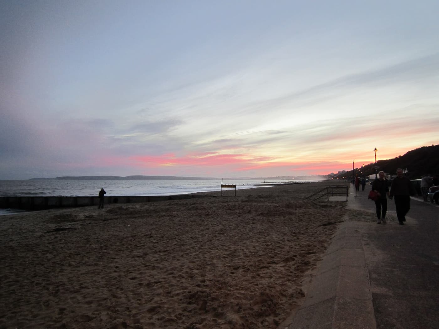 Boscombe Beach and promenade at sunset, with the pier reaching out into the bay
